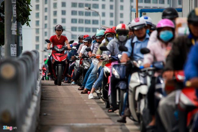 Nhiều xe máy bất chấp luật lệ phi lên hành lang dành cho người đi bộ để "thoát thân". Người dân xung quanh đây cho biết nhiều vụ tai nạn xảy ra do phương tiện đột ngột dừng lại chờ đèn tín hiệu khi từ trên cầu xuống.