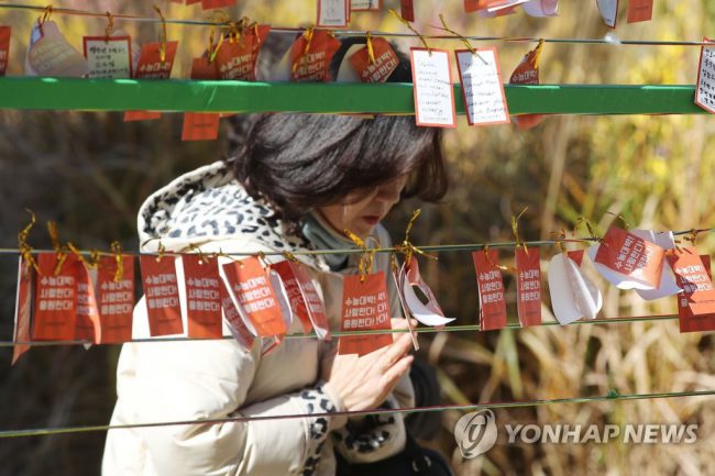 Trước ngày thi, nhiều phụ huynh đến đền, chùa, cầu nguyện cho con làm bài thuận lợi. Ở Hàn Quốc, đỗ đại học được xem là tấm vé thông hành, giúp bạn trẻ mở ra tương lai tốt đẹp, mang lại vinh hạnh cho gia đình. Vì thế, thí sinh và phụ huynh thường đến chùa cầu may trước khi bước vào kỳ thi. Ảnh: Yonhap.
